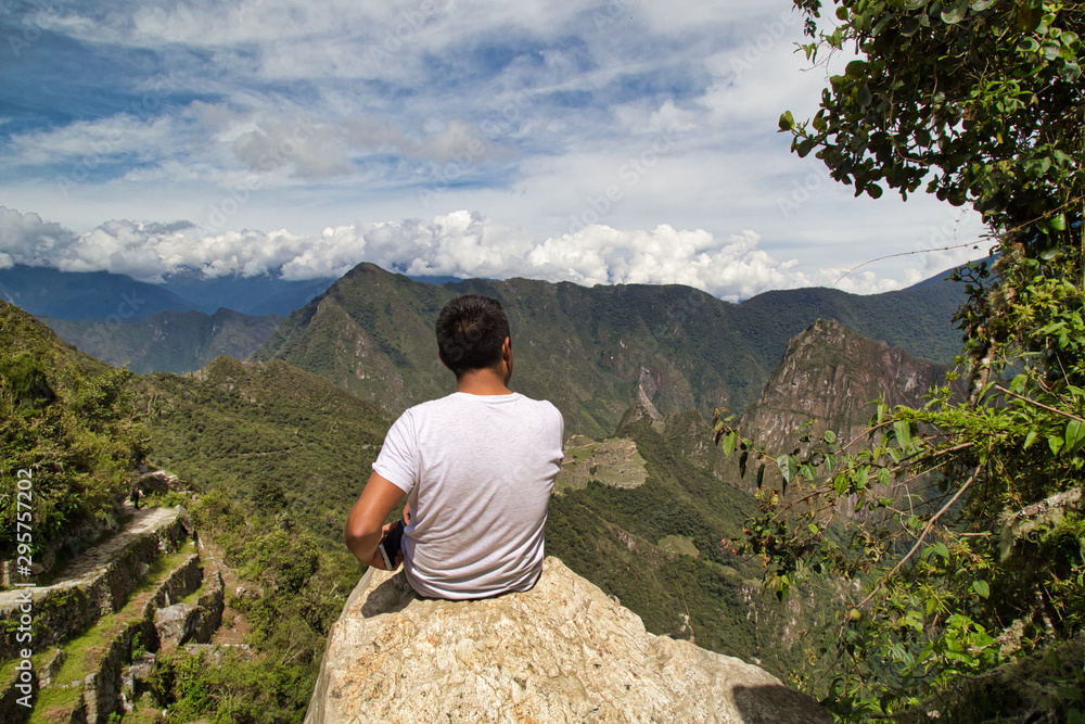 Traveller at the Lost city of the Incas, Machu Picchu,Peru on top of the mountain, with the view panoramic Traveller at the Lost city of the Incas, Machu Picchu,Peru on top of the mountain, with the view panoramic