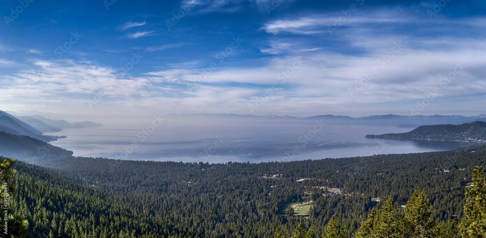 Lake Tahoe panorama with smoke from a wildfire along the mountains in early autumn
