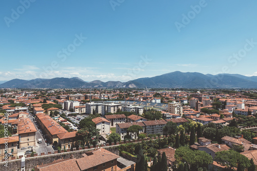 Panoramic view of Pisa city with historic buildings and far away mountains