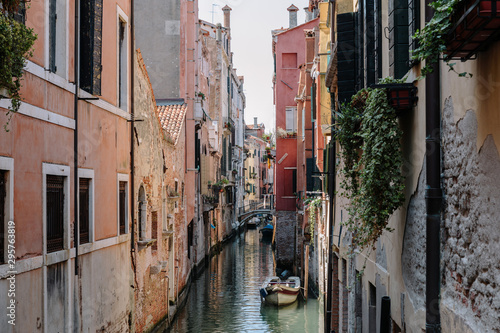 Panoramic view of Venice narrow canal with historical buildings and boat