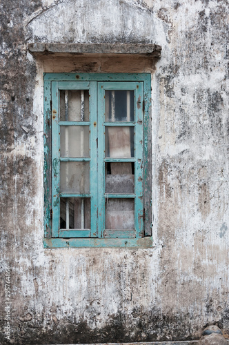 Broken window of an abandoned residential building © leeyiutung