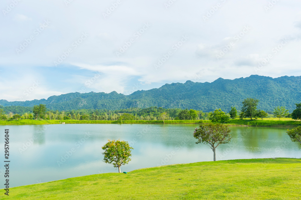 beautiful landscape overlooking the lake with clear clear water which reflects the mountains covered with green grass