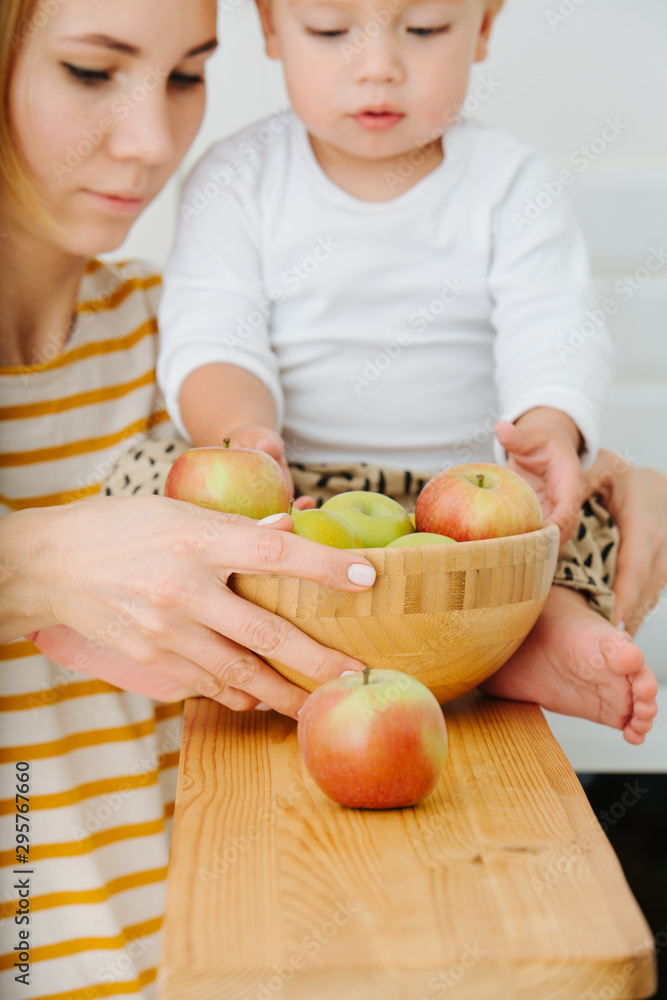 lly blond toddler boy is explores, plays with apples from backet. lly blond toddler boy is explores, plays with apples from backet.