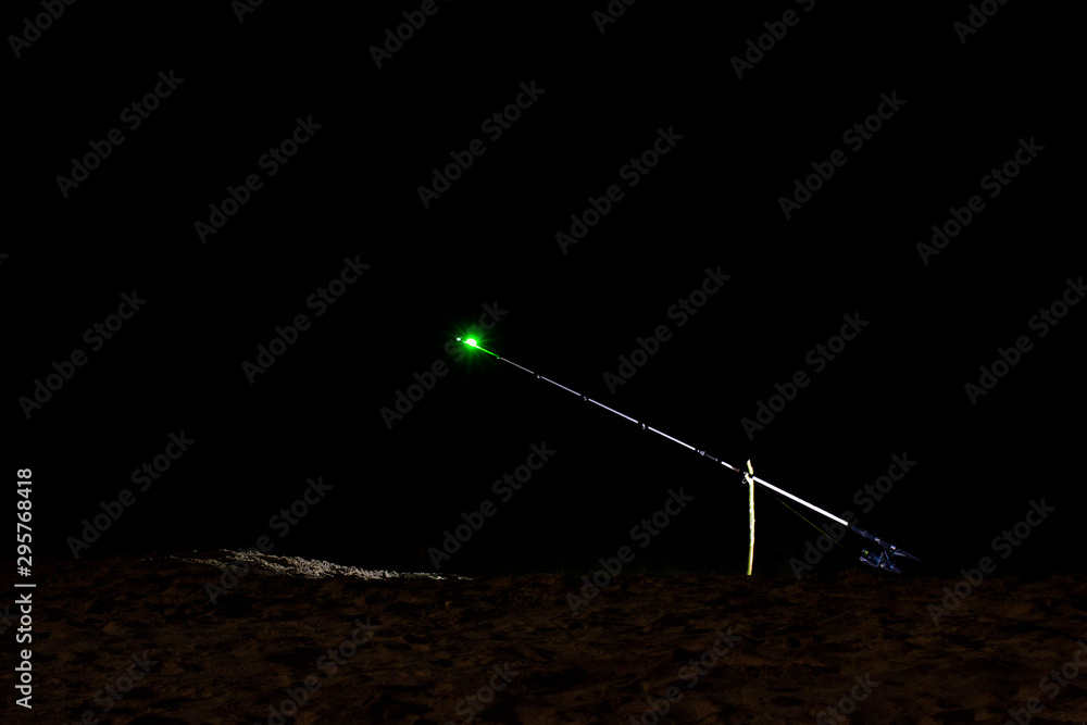 sanctifying fishing rods at night, the front and back background is blurred with bokeh effect sanctifying fishing rods at night, the front and back background is blurred with bokeh effect