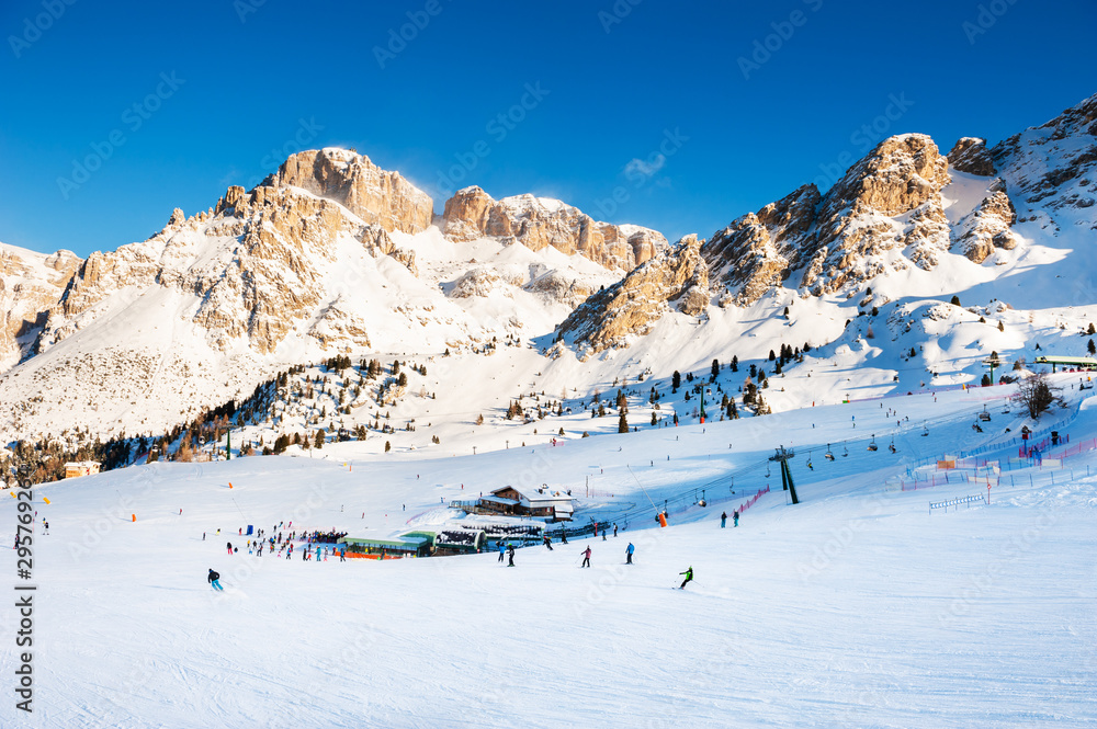 Ski slopes on ski resort in winter Dolomite Alps. Val Di Fassa, Italy. Winter holidays, travel destination