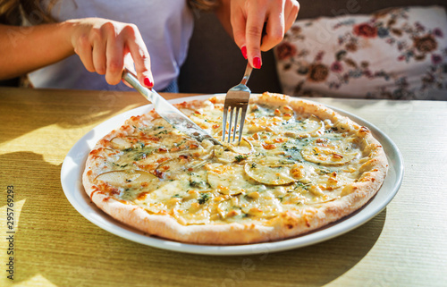 woman eating pizza in the cafe photo