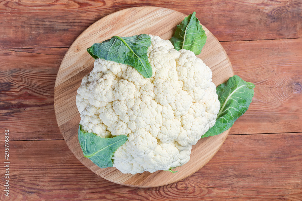 Top view of the cauliflower head on the wooden surface Top view of the cauliflower head on the wooden surface