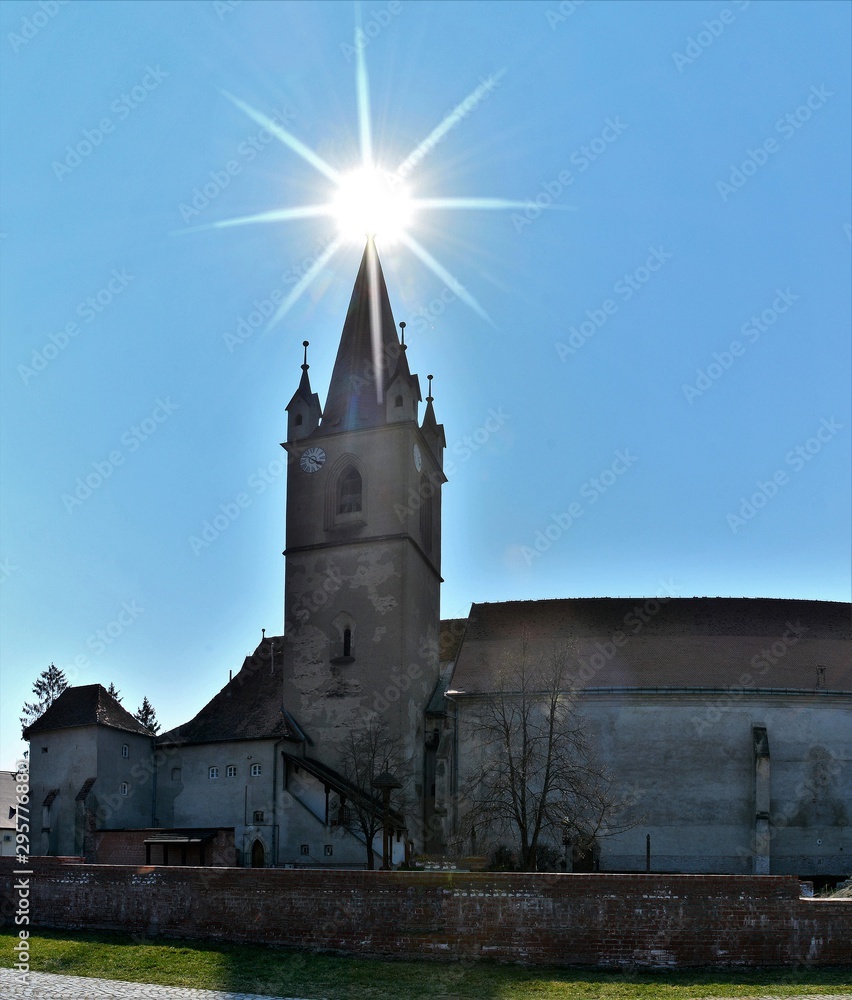 the church with the sun on top of the tower