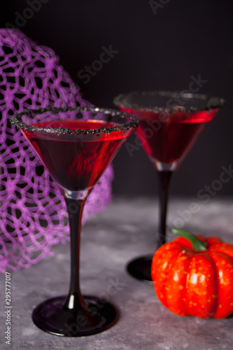 Two glasses with red cocktail for Halloween party on the dark background