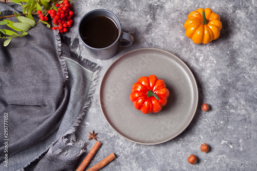 Composition with mug with coffee, autumn leaves, pumpkins, spices on the concrete background. Autumn harvest. Autumn concept. Top view. Copy space