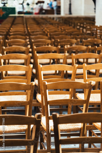 Empty chairs inside a church forming a pattern