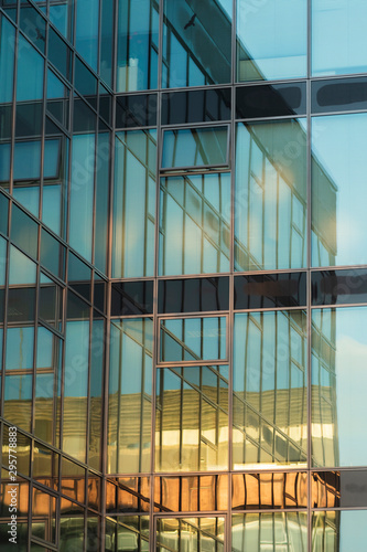 Close up of windows on a skyscraper at sunrise. office building modern architecture background.