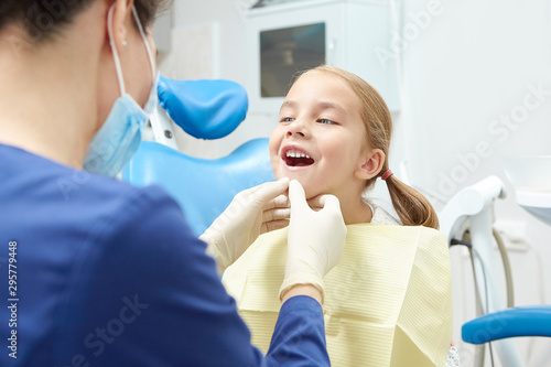 A little child in the examination at the dentist. Observation of teeth of young patient.