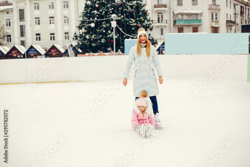 Family in a winter park. Mother with daughter in a ice arena © prostooleh