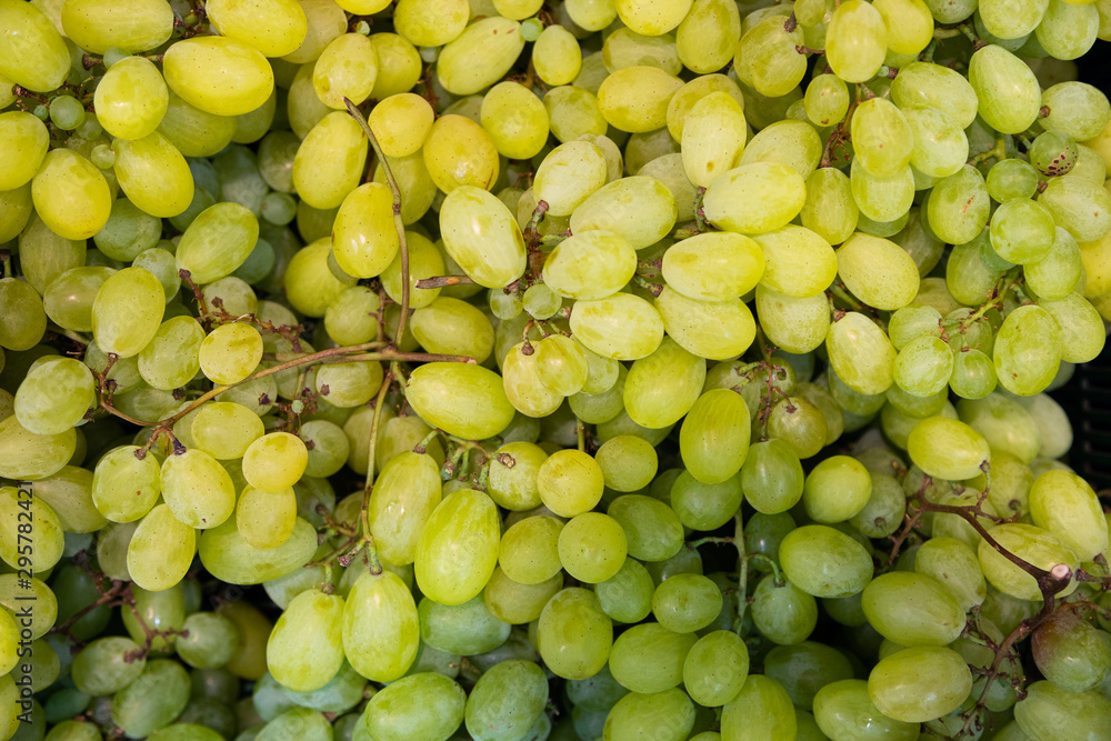 Juicy green grapes background at farmer's market shelves close-up Juicy green grapes background at farmer's market shelves close-up