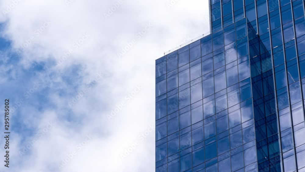4K UHD Time lapse of cloud with blue sky and windows reflection in high building. Business and development concept. 4K UHD Time lapse of cloud with blue sky and windows reflection in high building. Business and development concept.