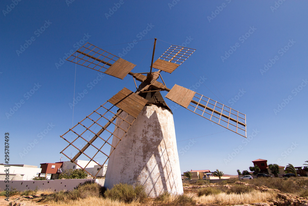 windmills in their habitat with blue sky