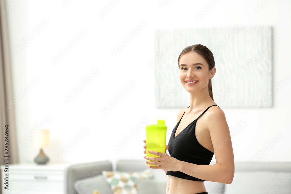 Athletic young woman with protein shake at home Athletic young woman with protein shake at home