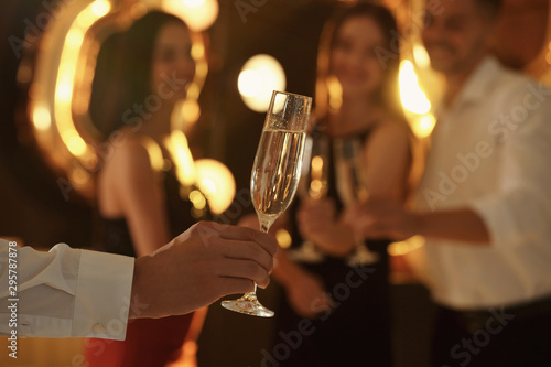 Man holding glass of champagne at New Year party, closeup