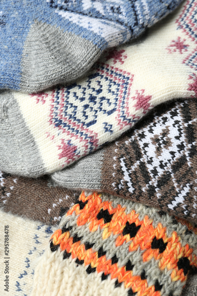 Fototapeta premium Different knitted woolen socks as background, closeup