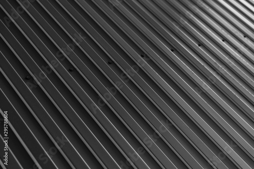 Black galvanized wall surface, diagonal view of textured background.