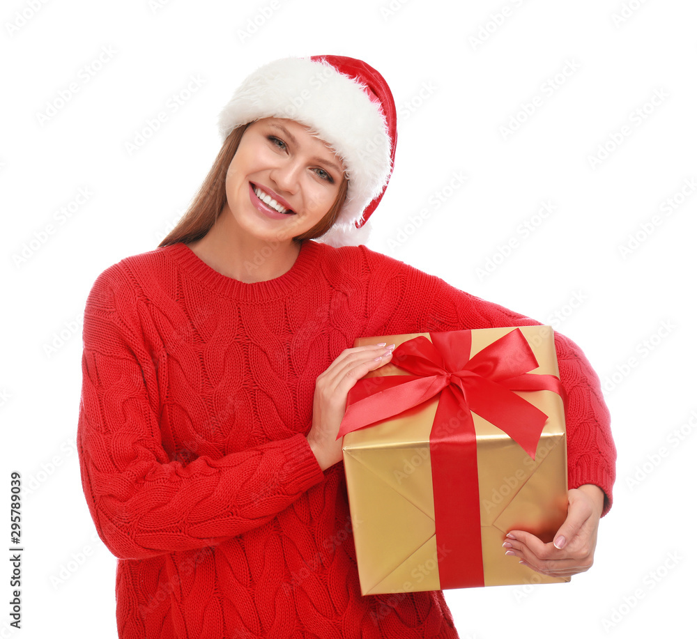 Happy young woman in Santa hat with Christmas gift on white background Happy young woman in Santa hat with Christmas gift on white background