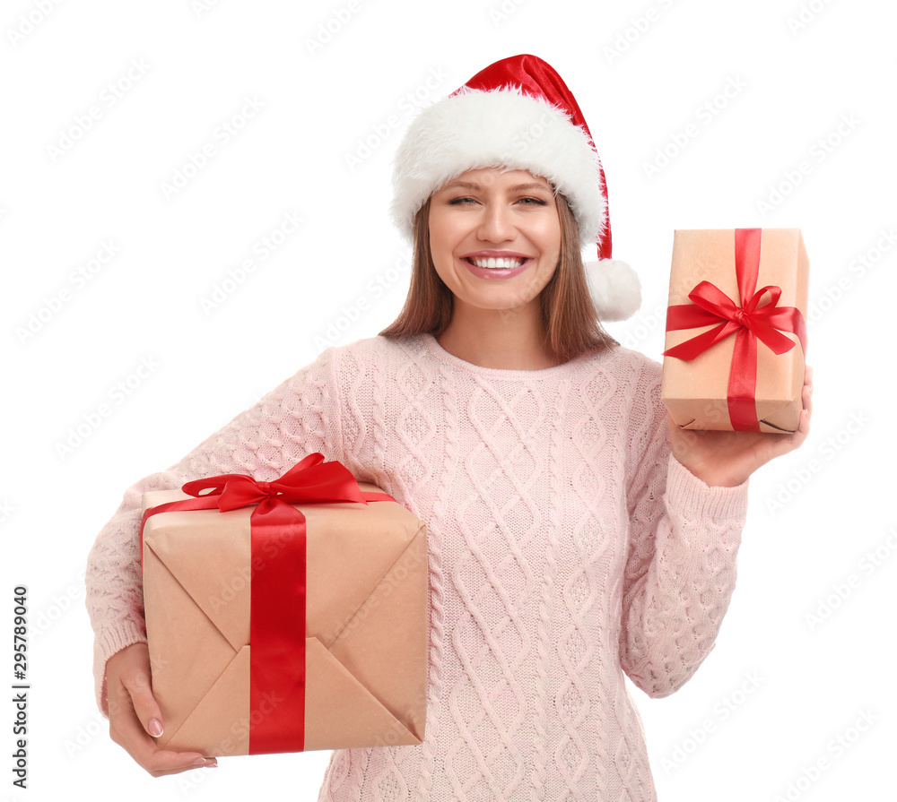 Happy young woman in Santa hat with Christmas gifts on white background Happy young woman in Santa hat with Christmas gifts on white background
