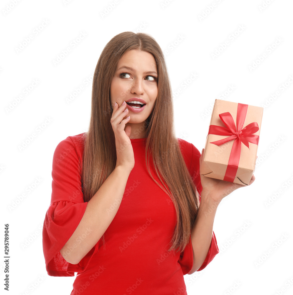 Emotional young woman with Christmas gift on white background Emotional young woman with Christmas gift on white background