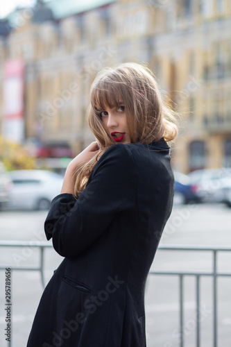 Stylish woman with long hair wears suit