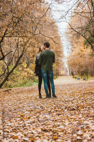 Young couple in love friends dressed in casual style walking together on autumn park © Galina Zhigalova