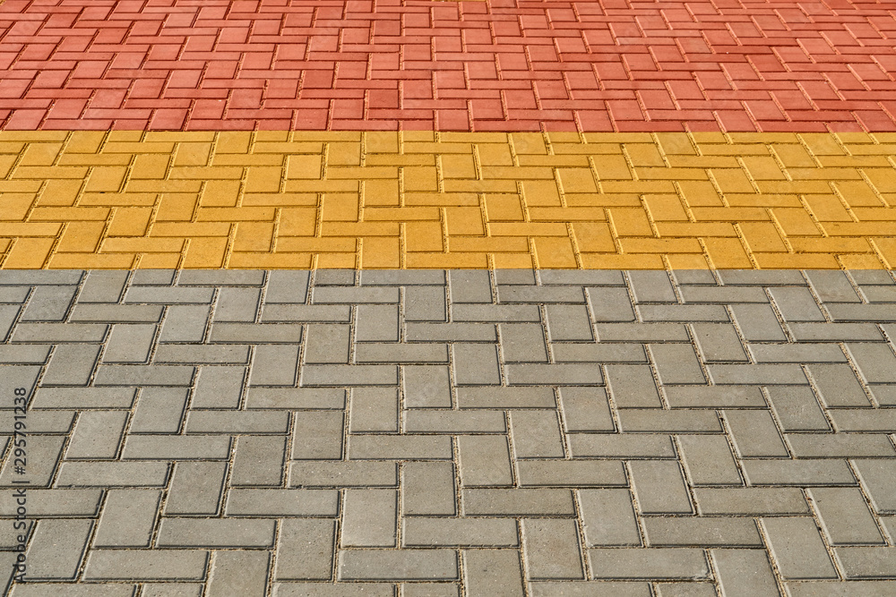 yellow, red and grey paving tiles for background or texture