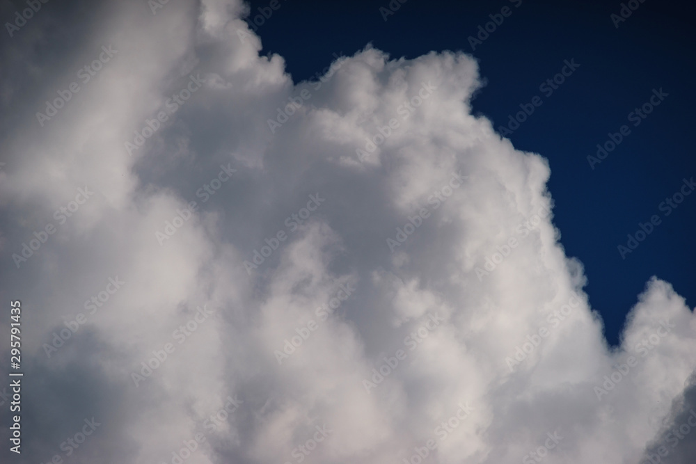 Large white cumulus clouds against a blue sky. Large white cumulus clouds against a blue sky.