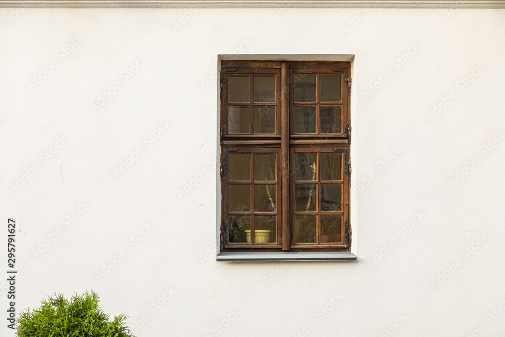 Rectangular wooden window in white wall