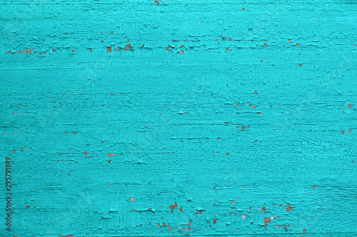 Texture of an old dry board with cracked faded green paint, background.