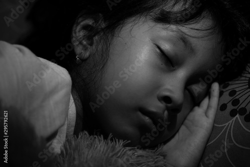 Black and white portrait of little Asian girl sleeping at home