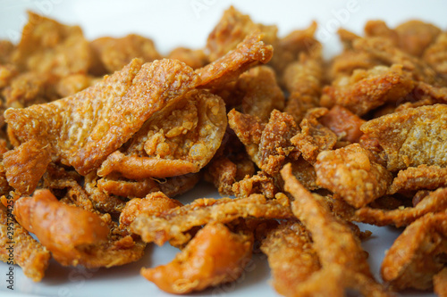 Close up browned crispy fried chicken skin Seasoned with salt, delicious snack.