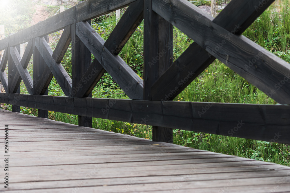 dark wooden bridge over river in a mountain forest dark wooden bridge over river in a mountain forest