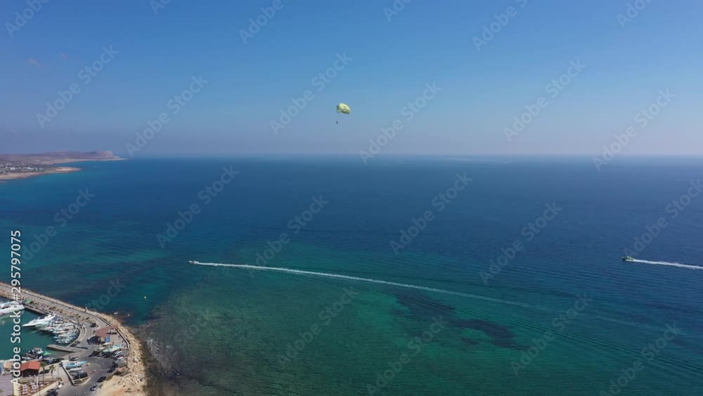 Aerial: Parasailing in the resort town of Ayia Napa, Cyprus Aerial: Parasailing in the resort town of Ayia Napa, Cyprus
