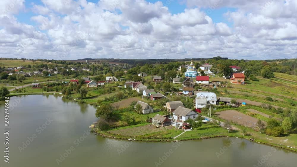 Aerial view of beautiful Village Landscape on a Hill Near the Lake. Moving the camera forward on the subject. Aerial view of beautiful Village Landscape on a Hill Near the Lake. Moving the camera forward on the subject.