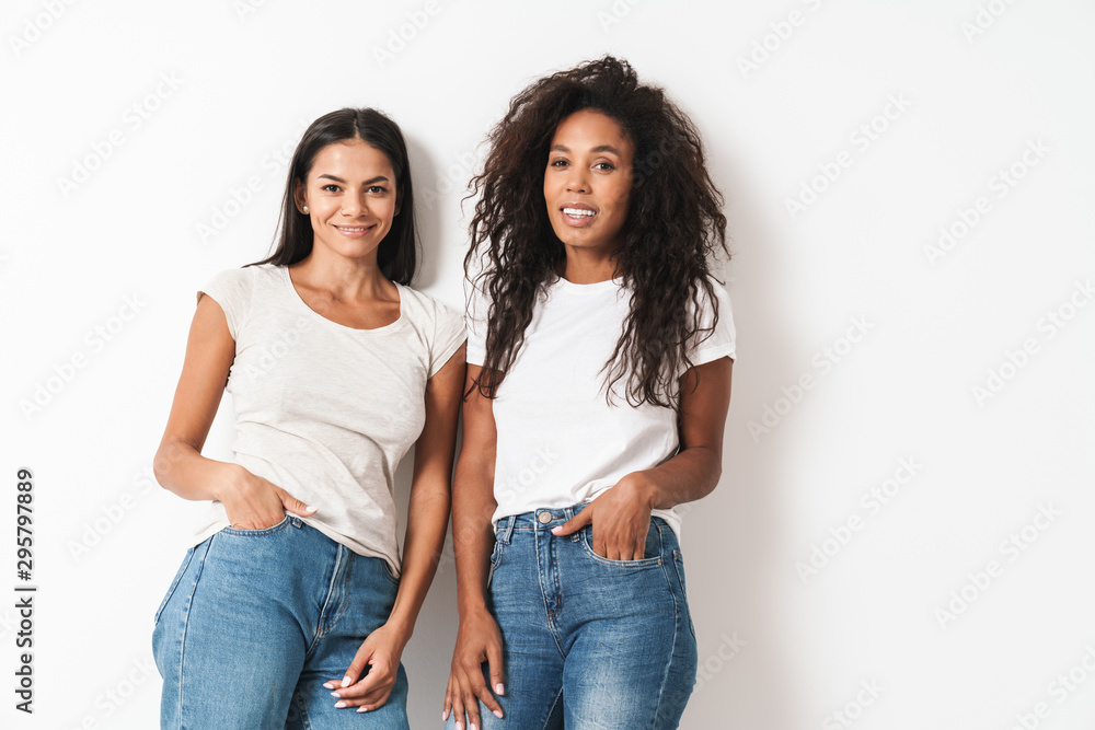 Multiracial friends posing isolated over white wall Multiracial friends posing isolated over white wall