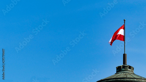 Austrian flag waving over blue sky. Austrian colors. flag red and white. austrian flag for banner 