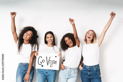 Fotografie, Obraz Friends posing isolated holding blank with motivation vegan text.