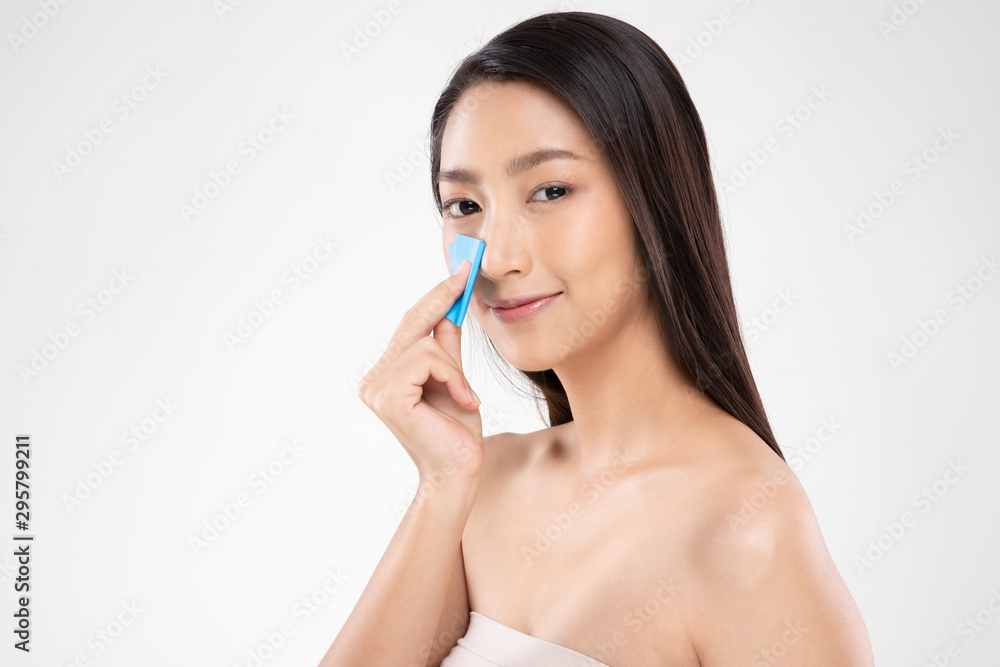 Beautiful Attractive Asian woman using Facial oil clean film to removal oily on face for face fresh skin feeling so fresh and clean,Beauty Concept,Isolated on grey background Beautiful Attractive Asian woman using Facial oil clean film to removal oily on face for face fresh skin feeling so fresh and clean,Beauty Concept,Isolated on grey background
