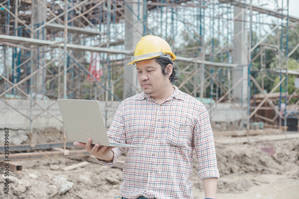 Engineer working on site, inspecting hands, using laptop site, construction concept, background construction concept Engineer working on site, inspecting hands, using laptop site, construction concept, background construction concept