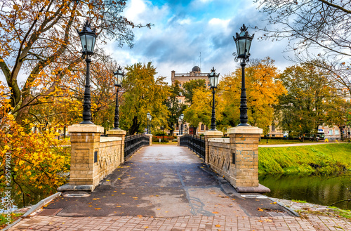 Central park with old stone bridge in Riga - capital and largest city of Latvia, a major cultural, historical and tourist center of the Baltic region