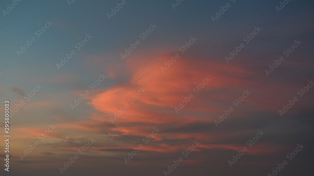 White cotton candy clouds on tropical blue sky at sunset, The horizon began to turn orange with purple and pink cloud at night, Dramatic cloudscape area