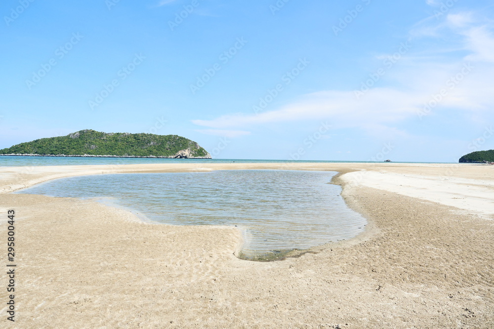 Calming sea with island and blue sky in background at Laem Sala Beach, Khao Sam Roi Yot National Park , Prachuap Khiri Khan , Thailand Calming sea with island and blue sky in background at Laem Sala Beach, Khao Sam Roi Yot National Park , Prachuap Khiri Khan , Thailand
