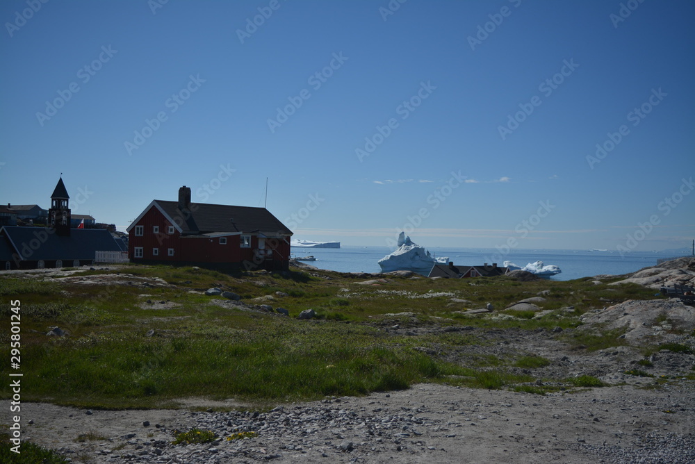 beautiful summer day in July in Ilulissat / view to the Disko Bay Greenland with buildings beautiful summer day in July in Ilulissat / view to the Disko Bay Greenland with buildings