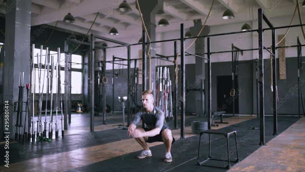 Powerlifting effective jumps. Male fitness instructor showing squat