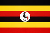 Republic of Uganda national fabric flag, textile background.